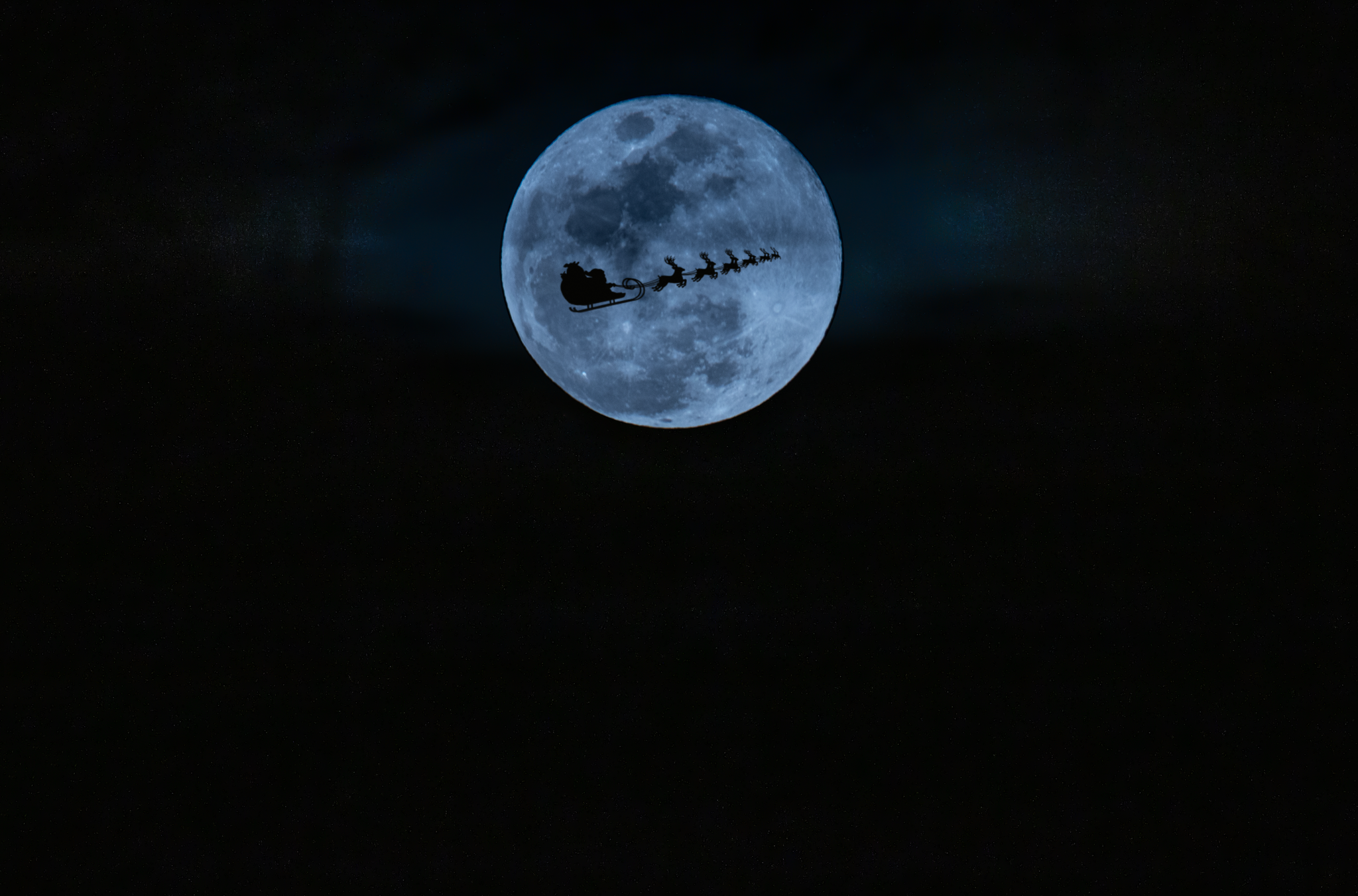 Santa flying over the moon